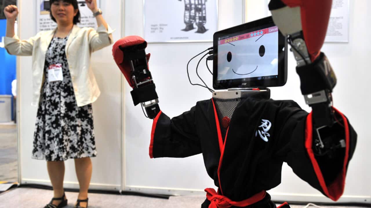 A robot dressed in a ninja costume mimics the actions of a person at the Robotech exhibition in Tokyo, Japan. (Getty Images)