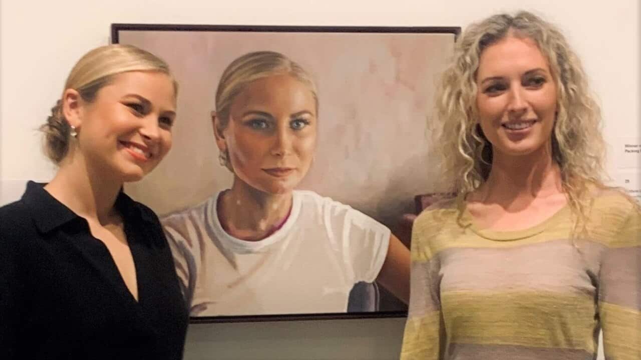 Grace Tame (left) with the portrait and artist Kirsty Neilson (right).