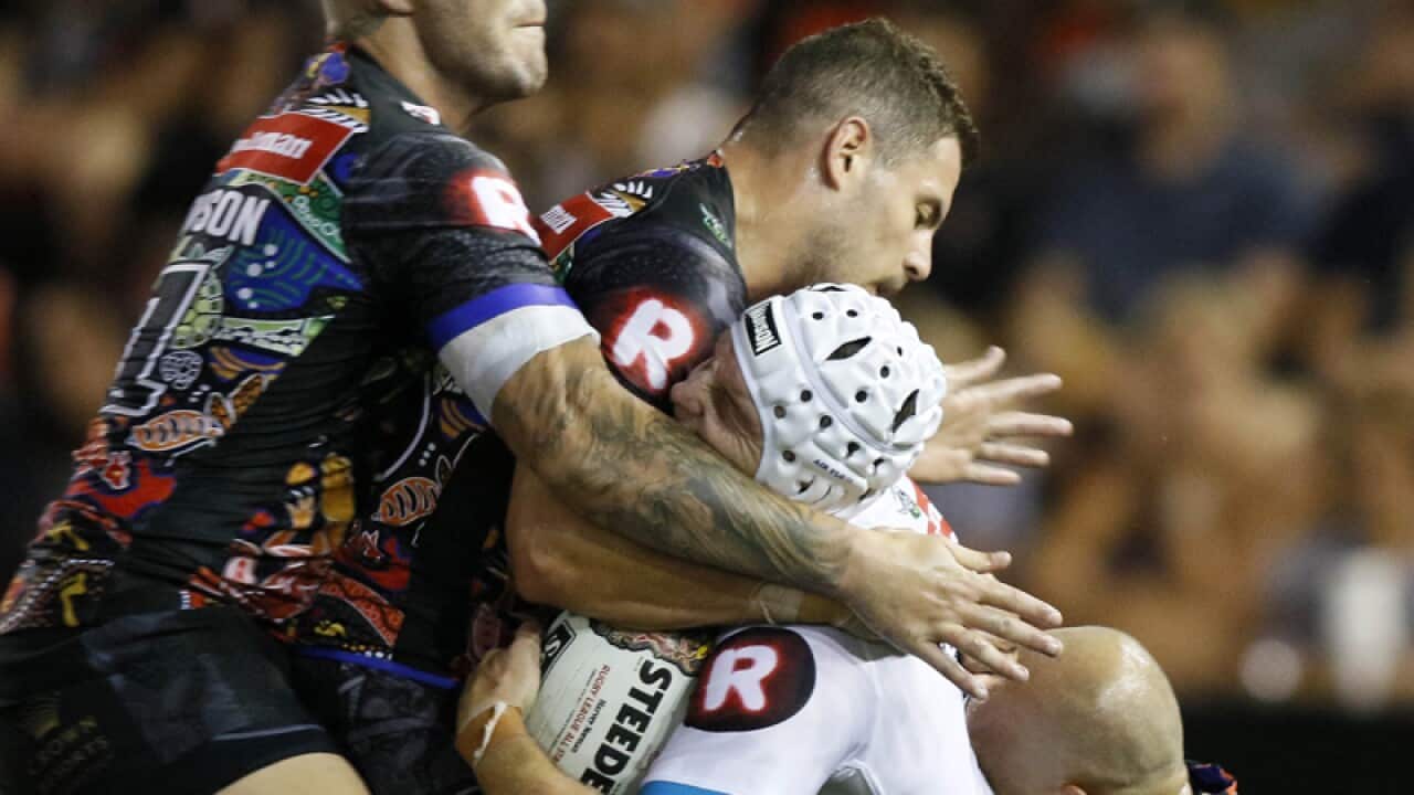 Jarrod Croker of the World All Stars is injured in a tackle