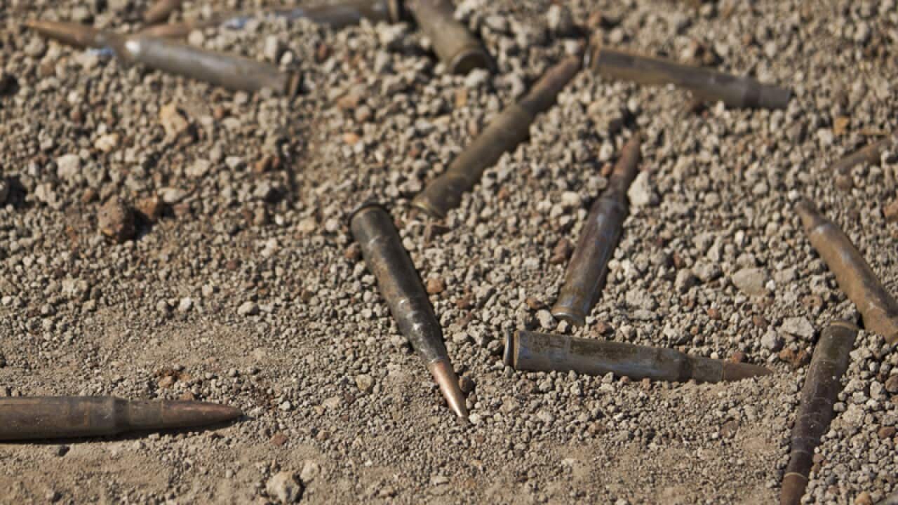 Unused ammunition lies on the ground