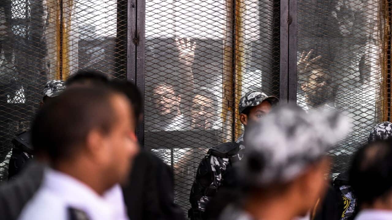 Members of Egypt's banned Muslim Brotherhood during their trial in July. 