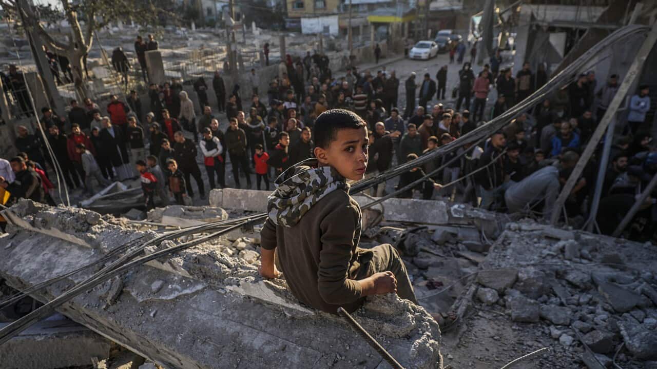 A child sitting on the remains of a building