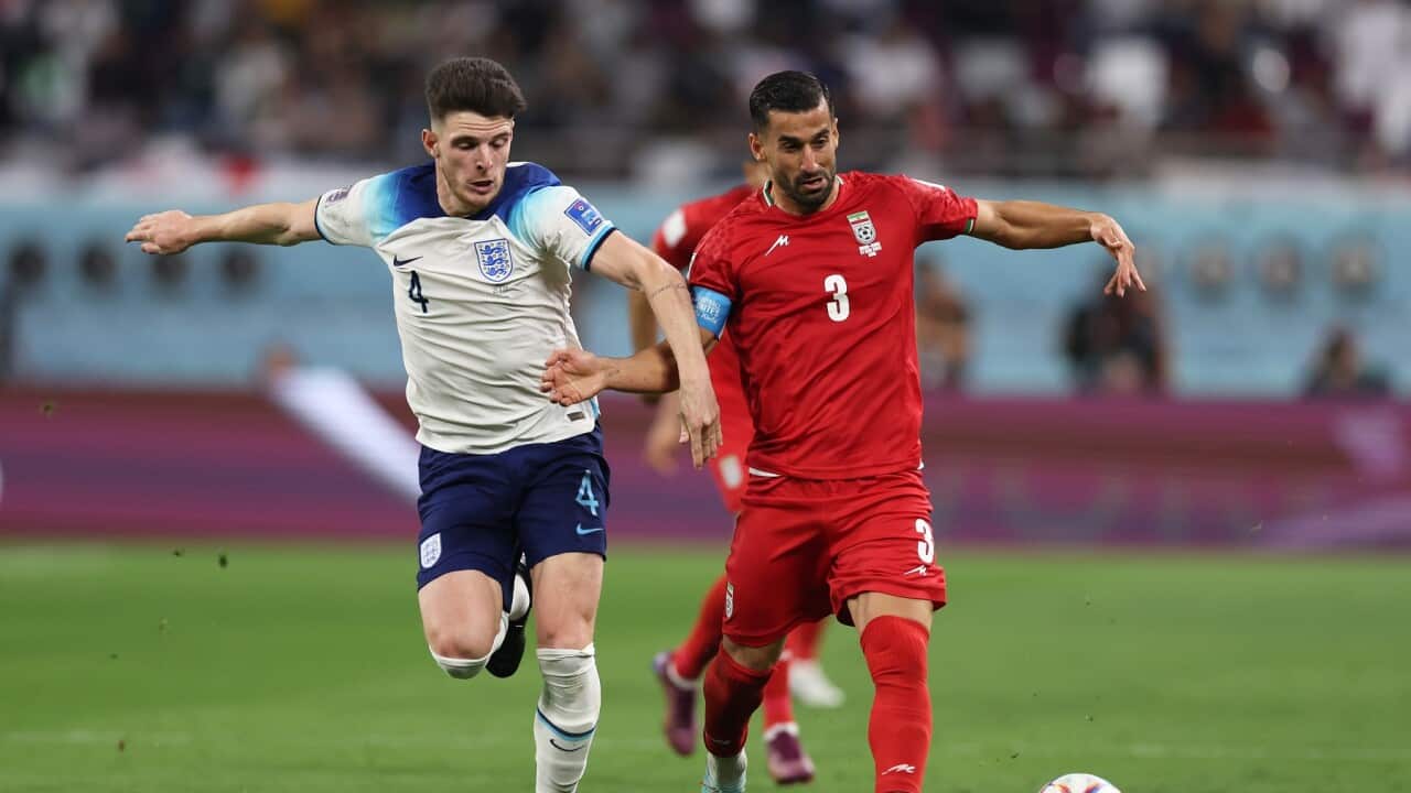 Declan Rice of England in action with Ehsan Hajisafi of Iran