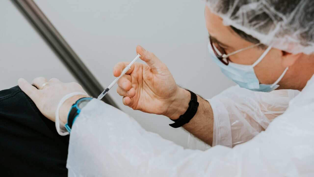 A medical staff is immunising a patient with vaccine - Mat Napo - Unsplash