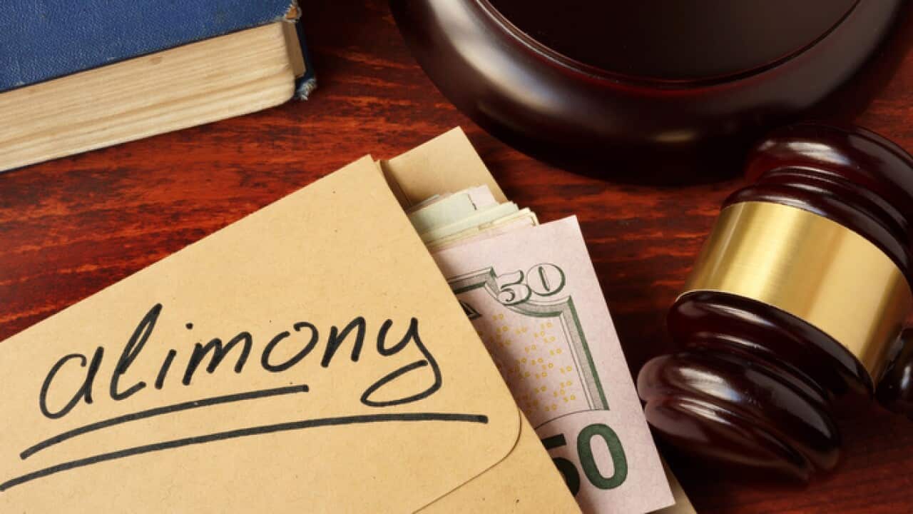 Alimony concept. An envelope with cash on a table.