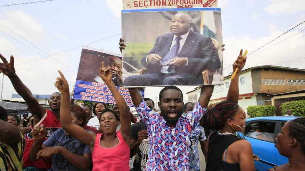 Supporters of the former Ivory Coast president Laurent Gbagbo celebrate on the announcement of his being acquitted of war crimes.