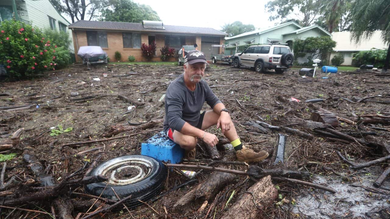 Resident Shaun Ratko sits outside his home in Port Macquarie on Tuesday.