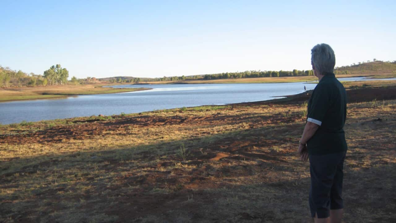 A local woman looks out across Chinaman Creek near Cloncurry