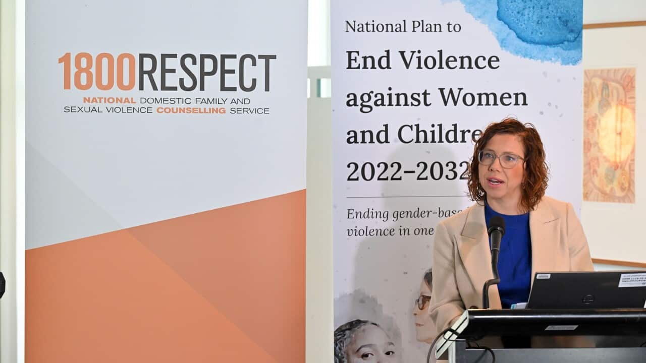 Social Services Minister Amanda Rishworth at the podium in front of a 1800RESPECT banner.