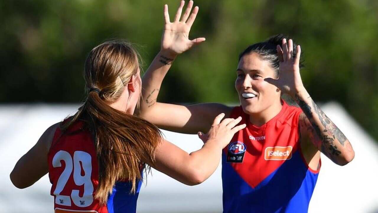 Eden Zanker (left) of the Demons celebrates kicking a goal