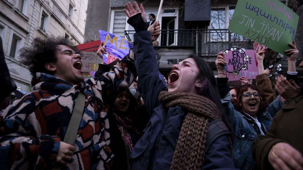 Women hold slogans during a march marking the International Women’s Day near Taksim square in Istanbul