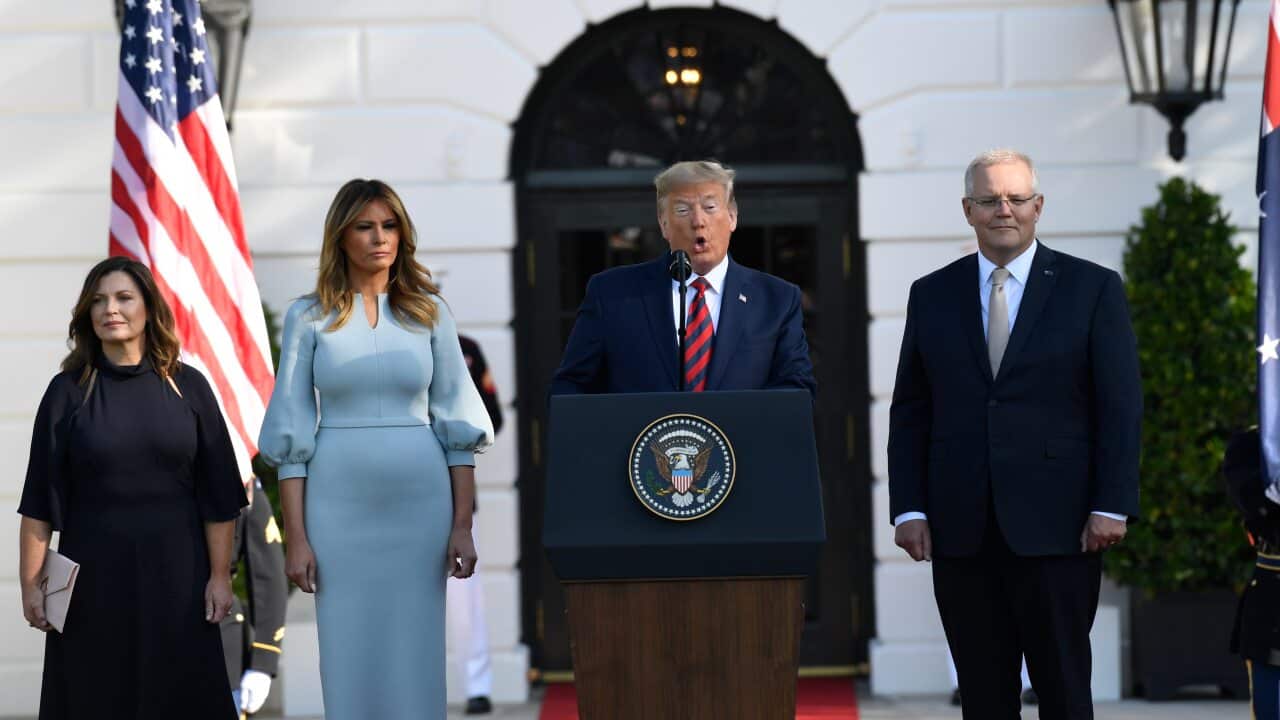 President Donald Trump speaks as Scott Morrison, Jenny Morrison (left) and Melania Trump listen.