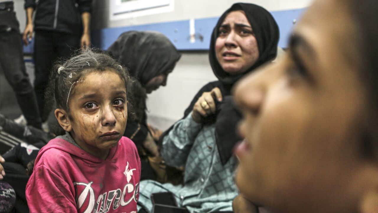 Wounded Palestinians sit in al-Shifa hospital in Gaza City, central Gaza Strip, after arriving from al-Ahli hospital following an explosion there, Tuesday, Oct. 17, 2023.