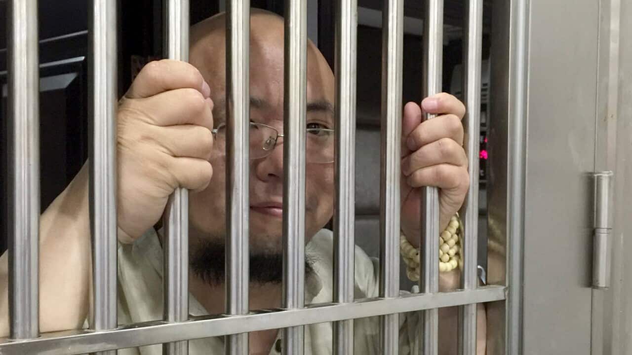 FILE: Wu Gan seen behind bars at police station in Nanchang city in May 2015.
