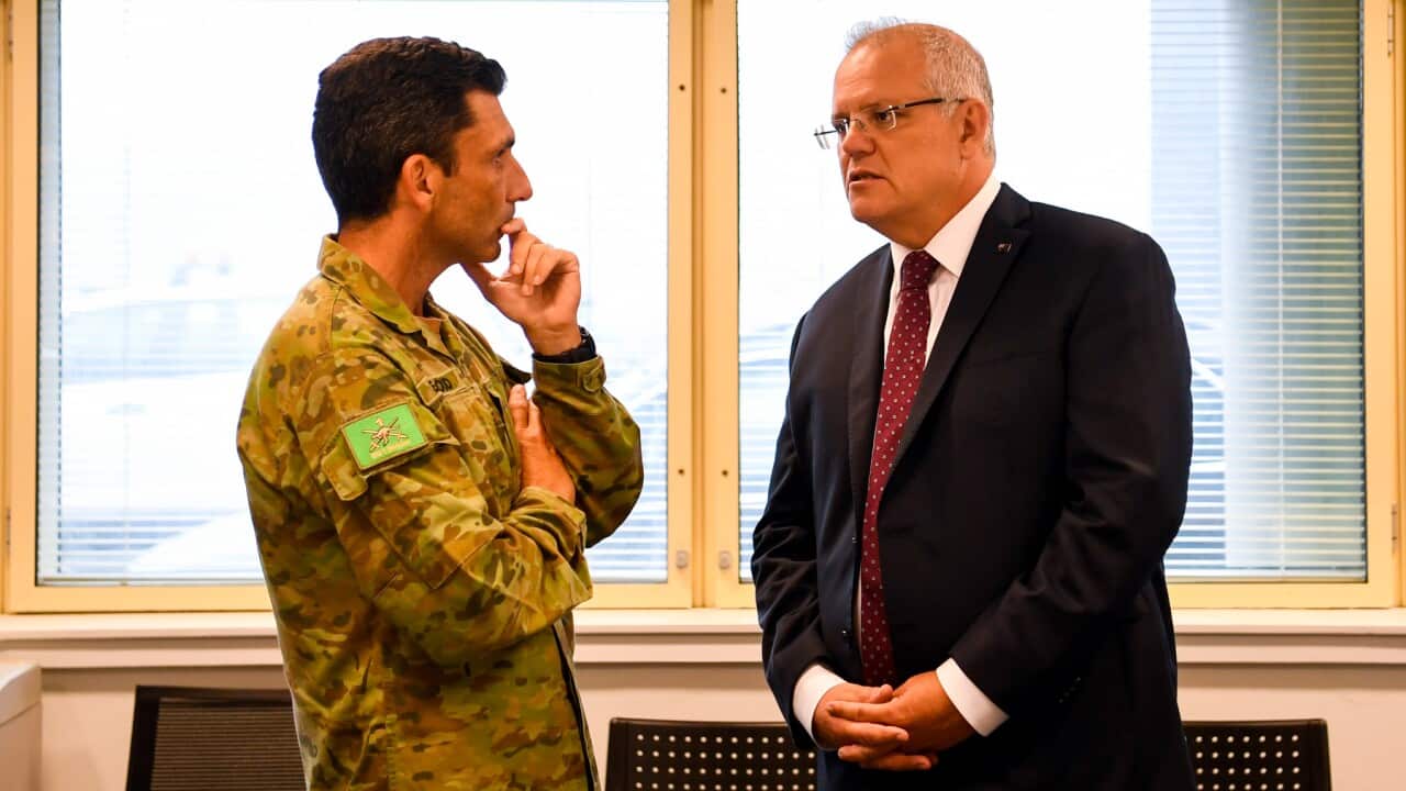 Prime Minister Scott Morrison (right) speaks to Emergency ADF National Support Co-ordinator Major General Justin Ellwood.
