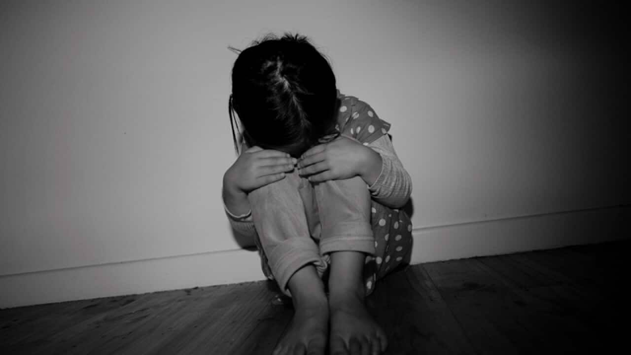A posed image depicting child abuse.