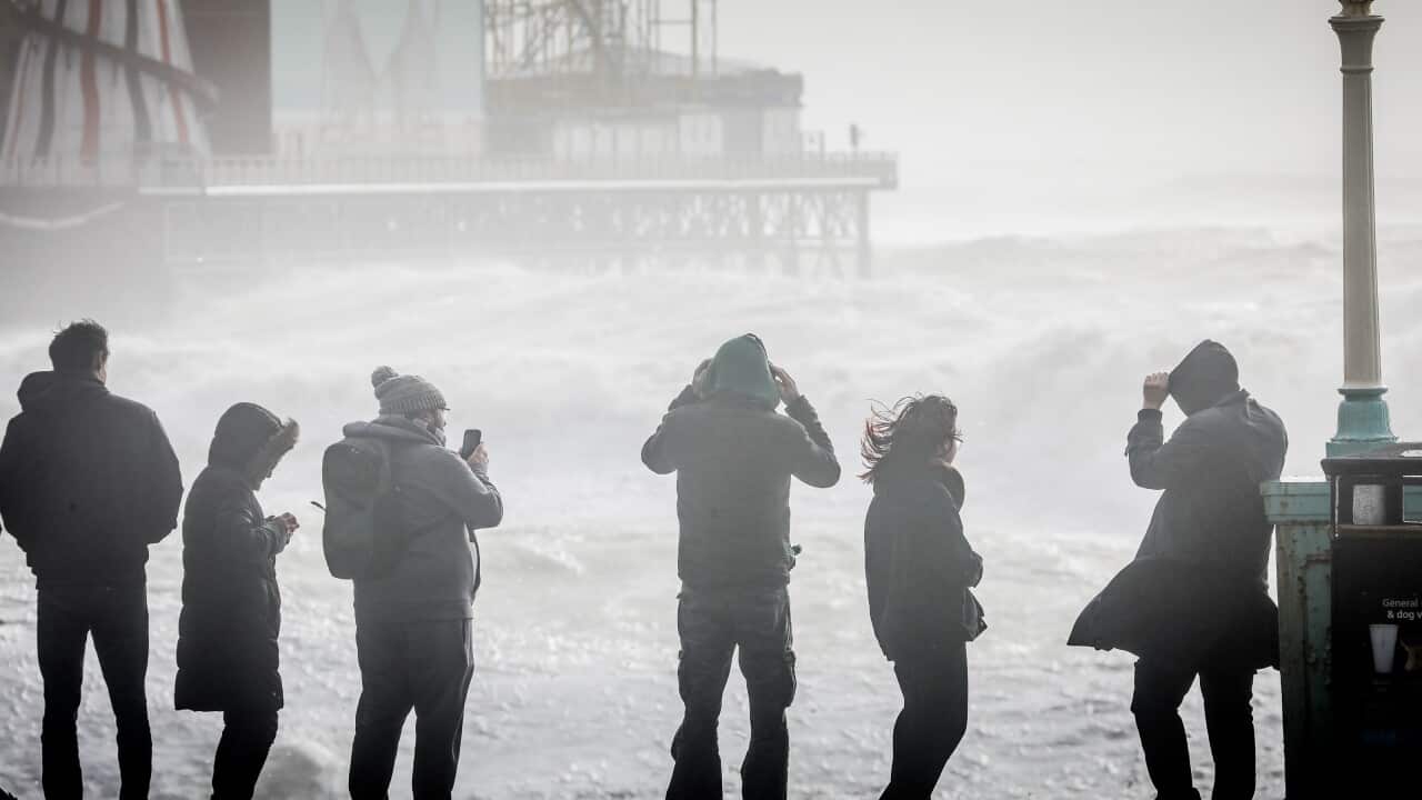 People watch as storm waves break against Brighton Palace Pier on 18 February, 2022 in Brighton, England. 