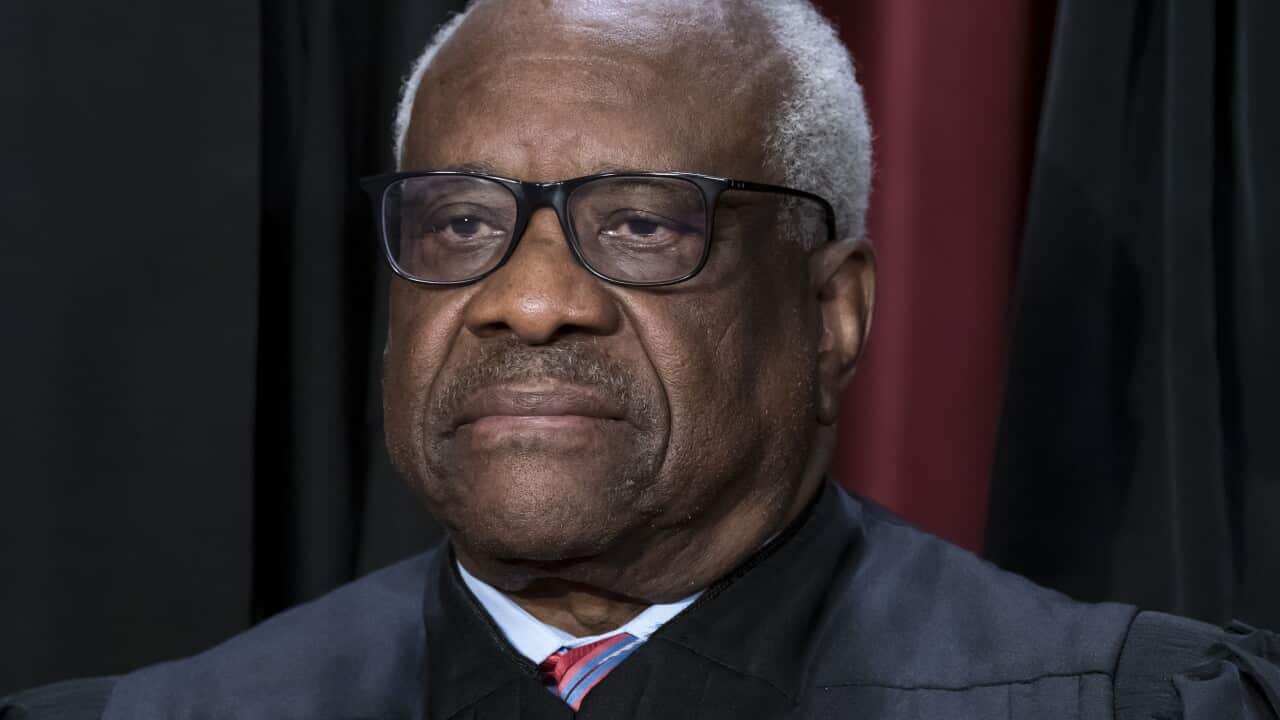 A man wearing glasses looking away from the camera.