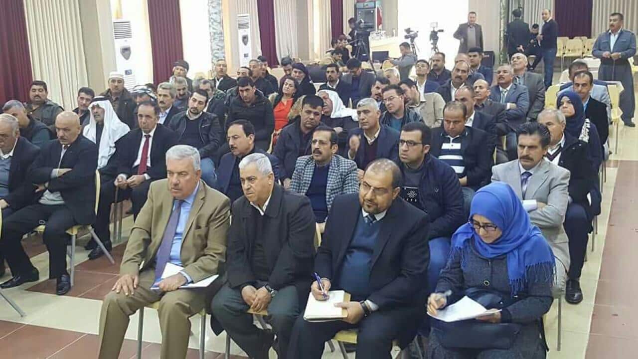 People gather in a forum to discuss the movement