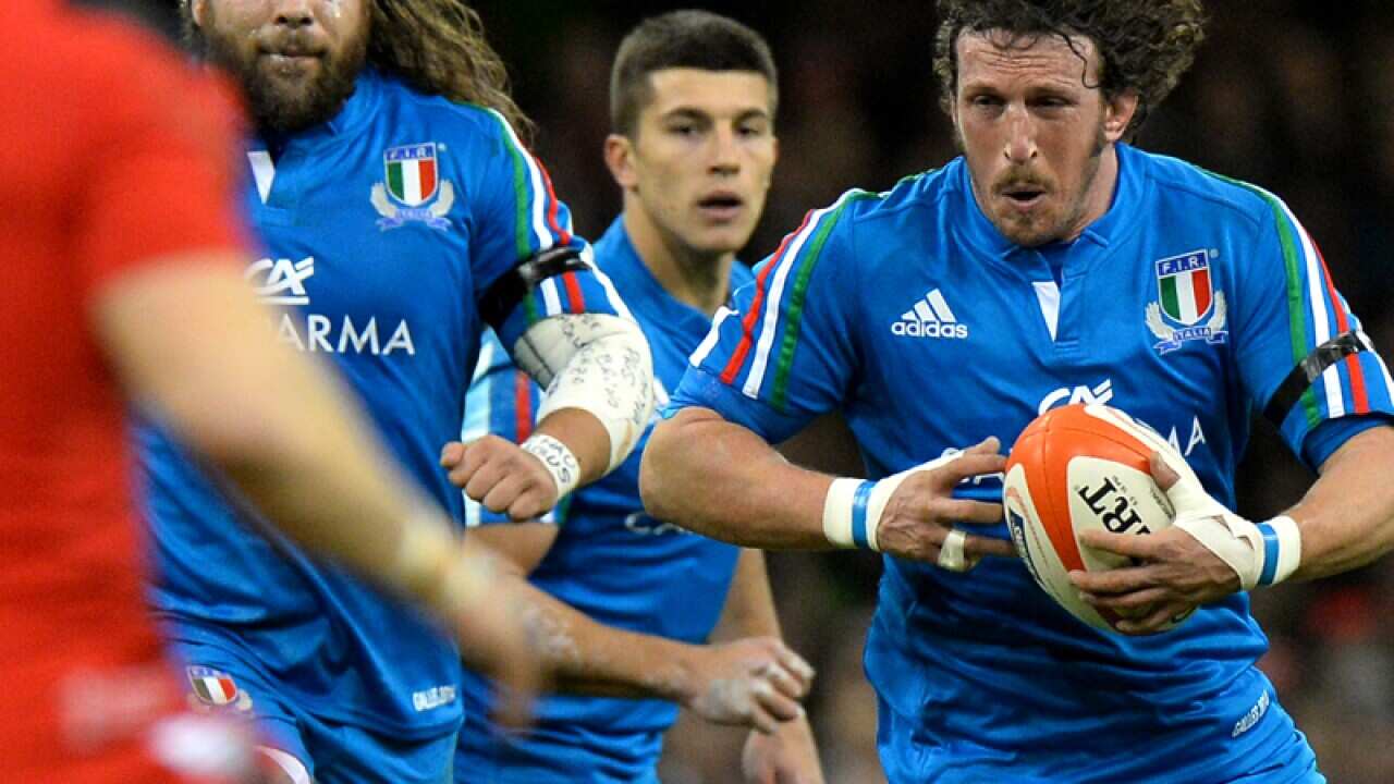 Italy's flanker Mauro Bergamasco (R) runs with the ball