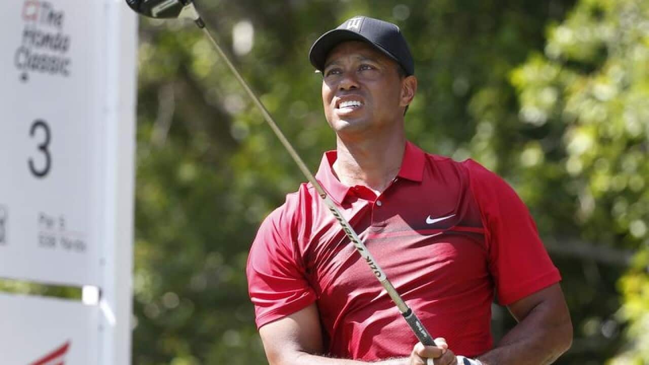 Tiger Woods tees off.