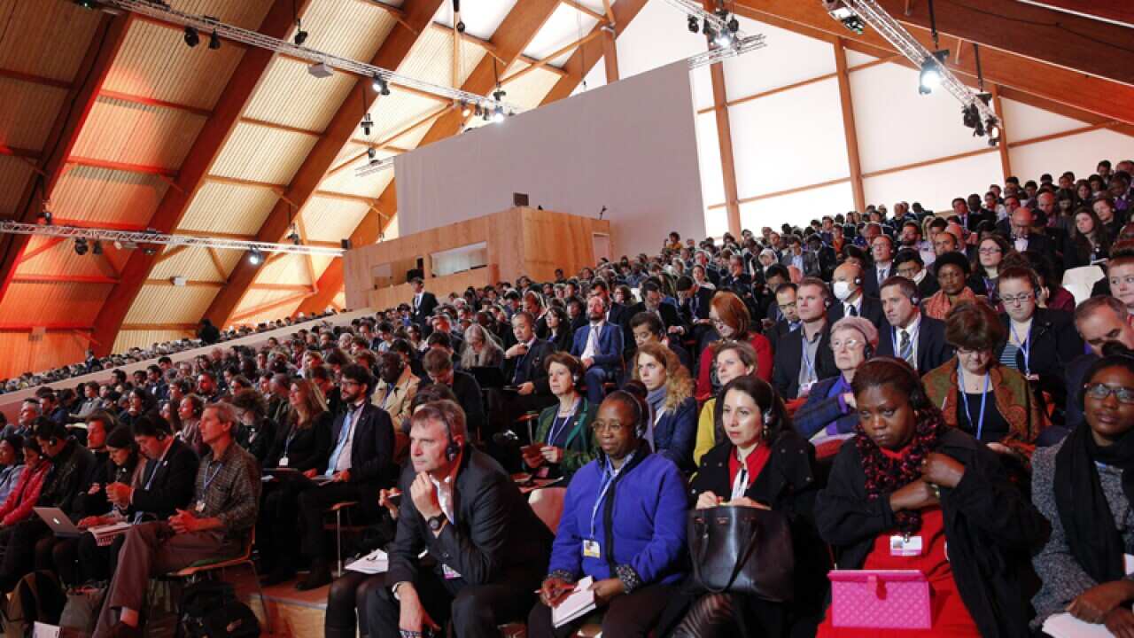 Participants attend a conference at the COP21 conference in Paris