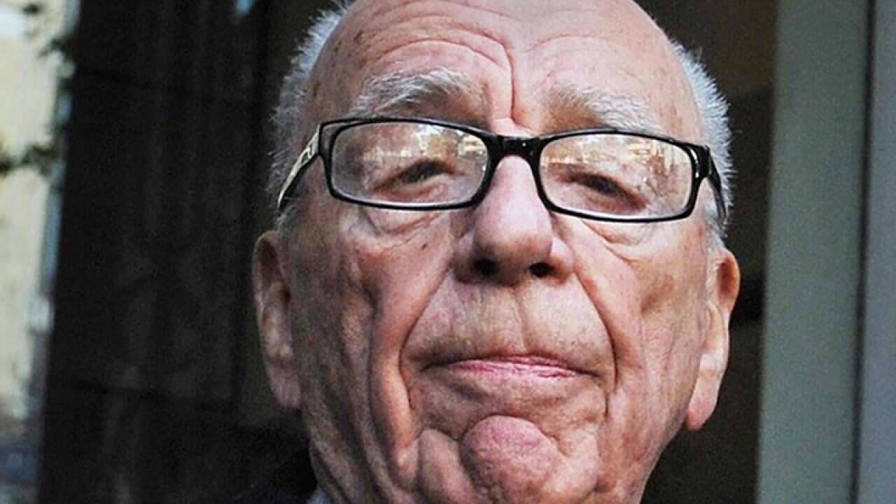 Murdoch rows back on hacking probe