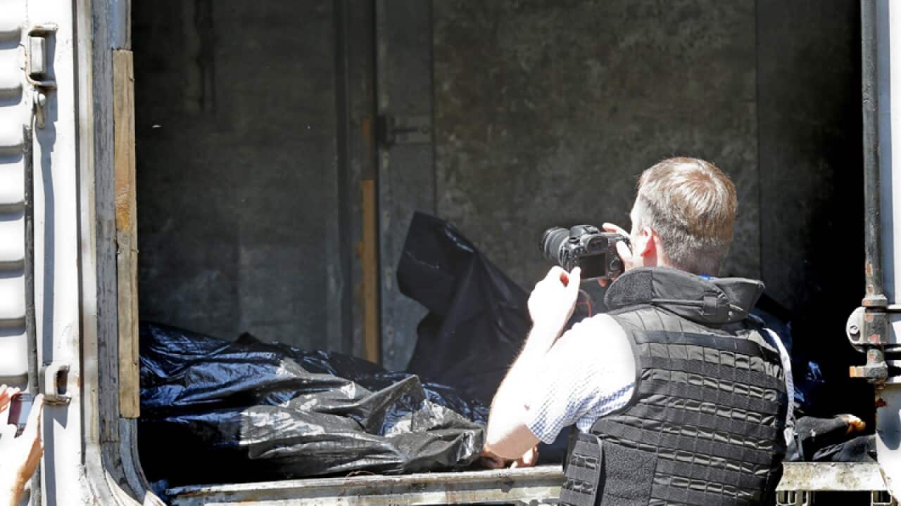 inspectors document the body bags from downed flight MH17