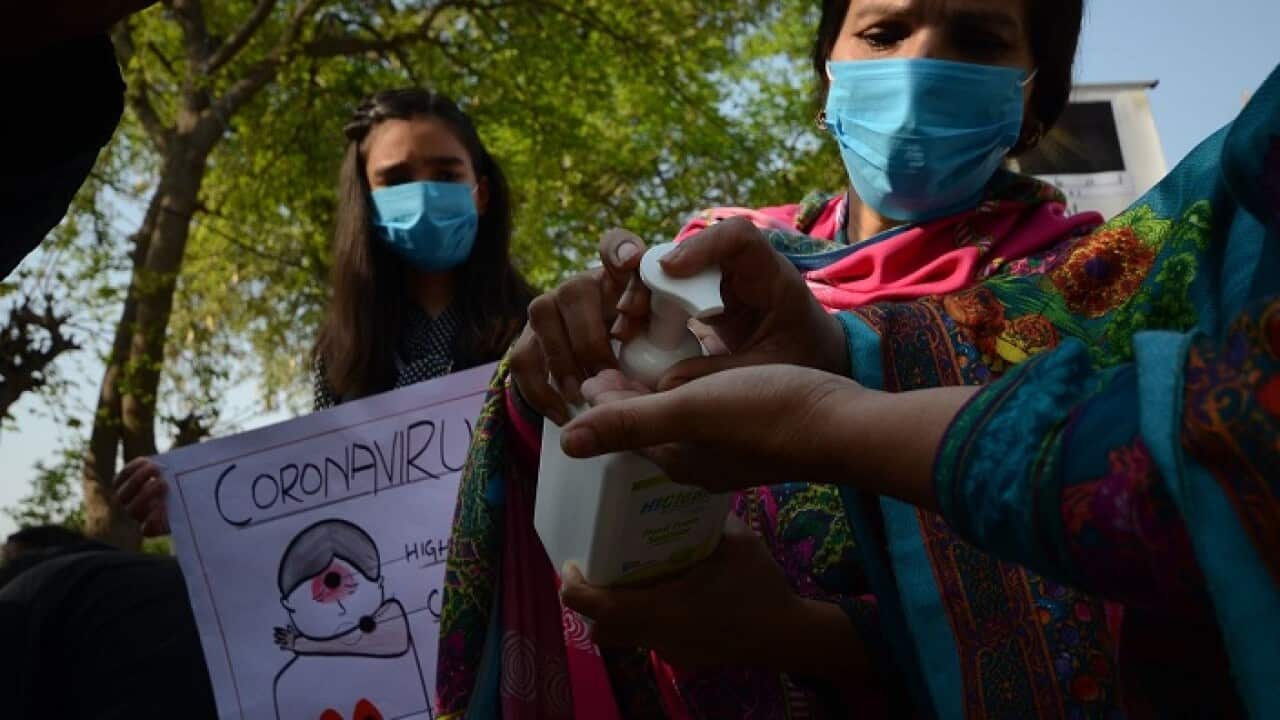 Pakistani Christians clean there hands with sanitizer to protect from Corona virus before praying at St. Johns cathedral church in Peshawer.