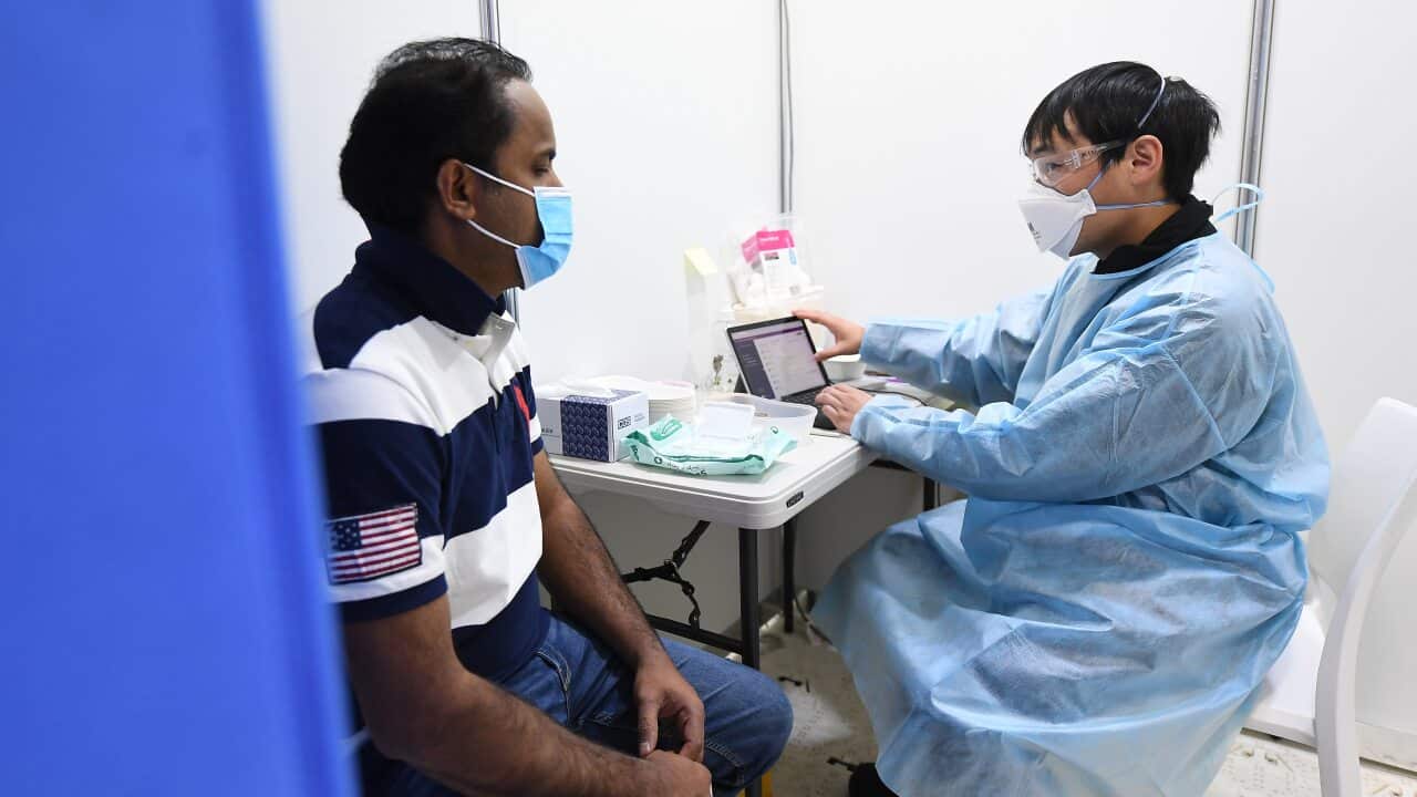 Rayees Mohammed (left) speaks with healthcare worker Chee Kin Lee prior to receiving his Covid19 vaccination at a pop-up Covid-19 vaccination clinic at the Australian Islamic Centre in Newport, Melbourne, Friday, September 10, 2021. (AAP Image/James Ross)