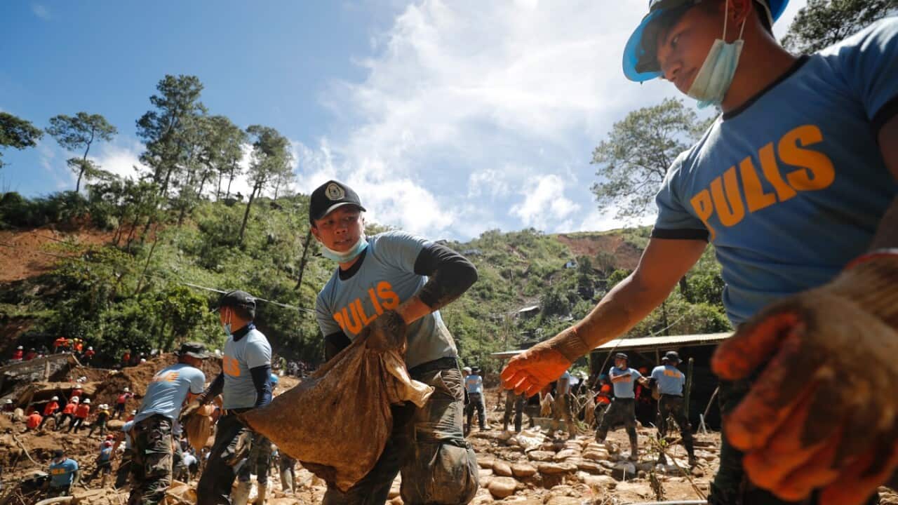 Rescuers continue to work during rescue and retrieval operation for landslide victims caused by Typhoon Mangkhut in Ucab village, Itogon town