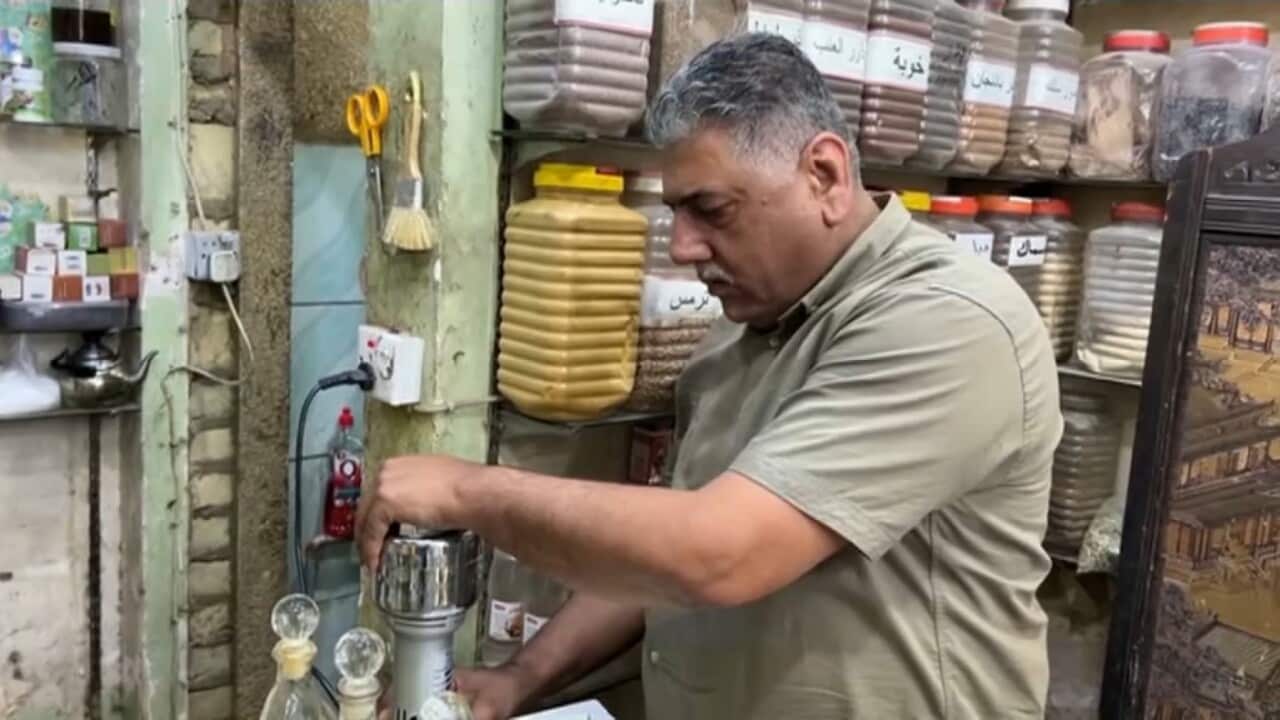 Mohammed Sobhi working in his herbal remedy shop (Reuters).jpg