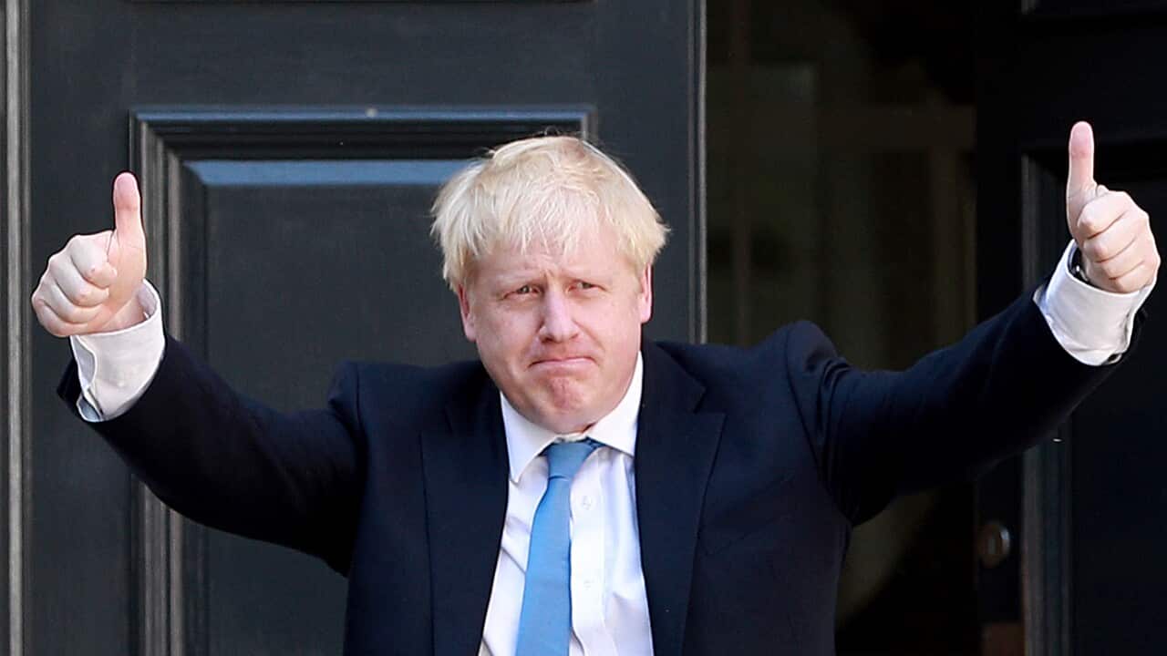 Newly elected Conservative party leader Boris Johnson poses outside the Conservative Leadership Headquarters