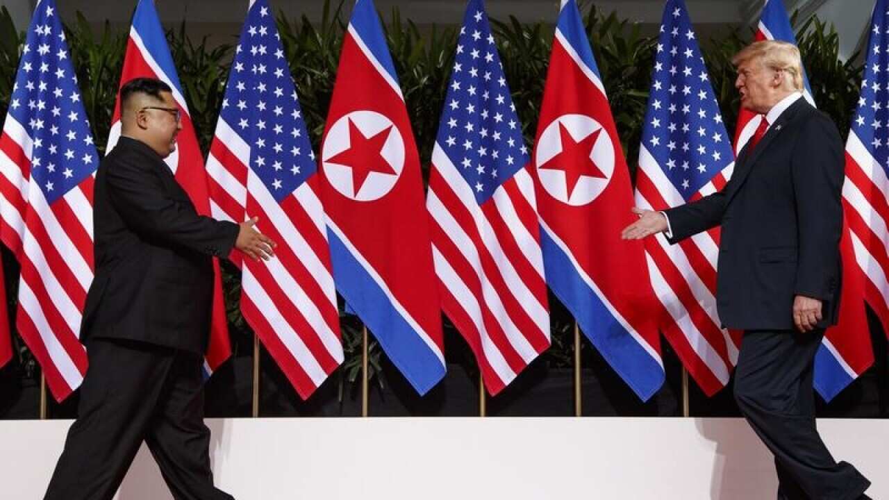 Kim Jong-un walks towards Donald Trump at their Singapore summit.