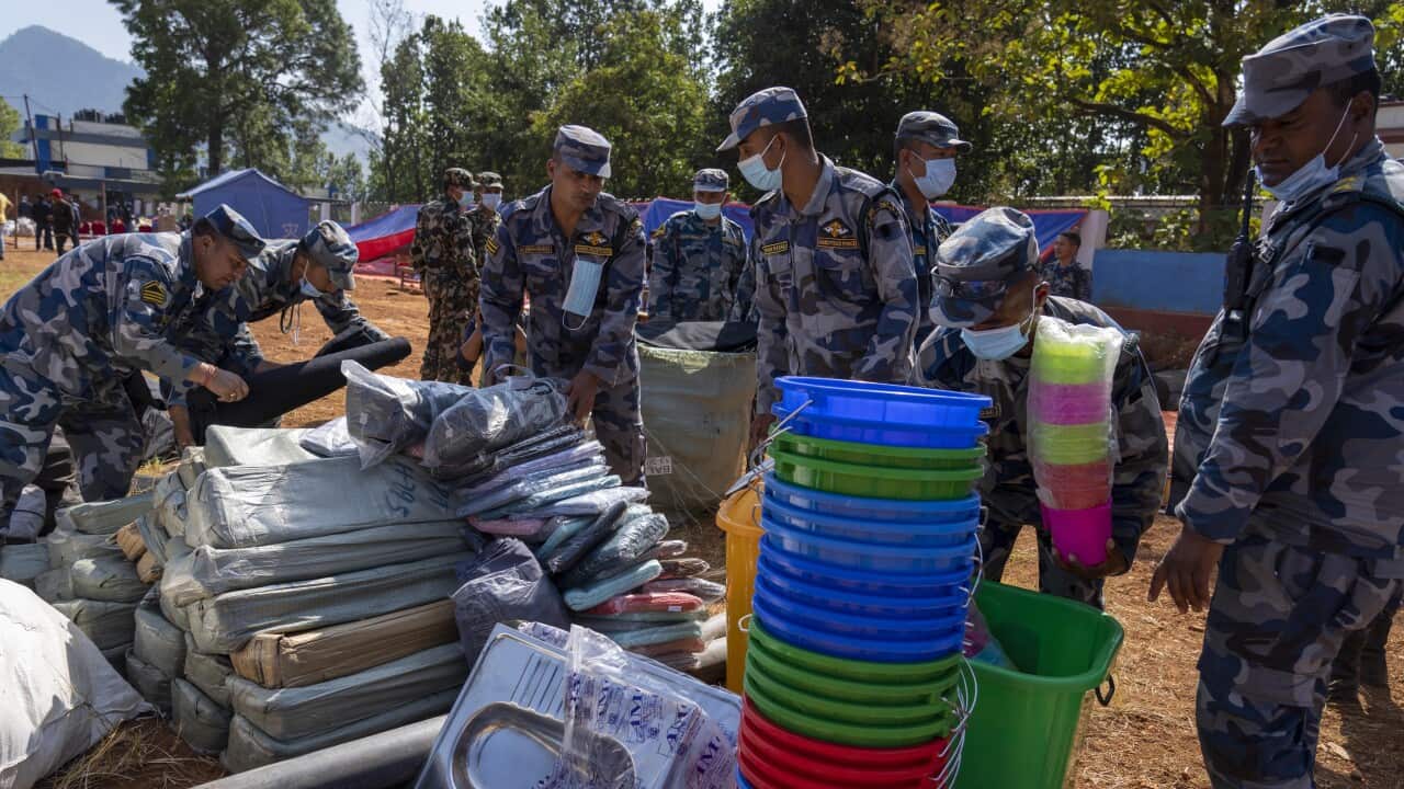 Policemen pack relief material to distribute among earthquake survivors in Jajarkot District, northwestern Nepal, Monday, 6 November 2023.