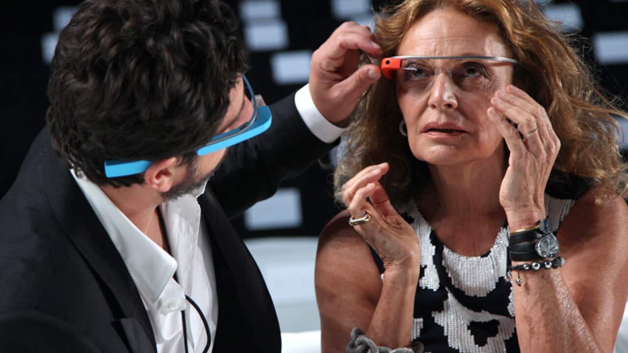 Google co-founder Sergey Brin helps fashion designer Diane Von Furstenberg adjust her Google Glass headwear. (AP Photo/Seth Wenig)