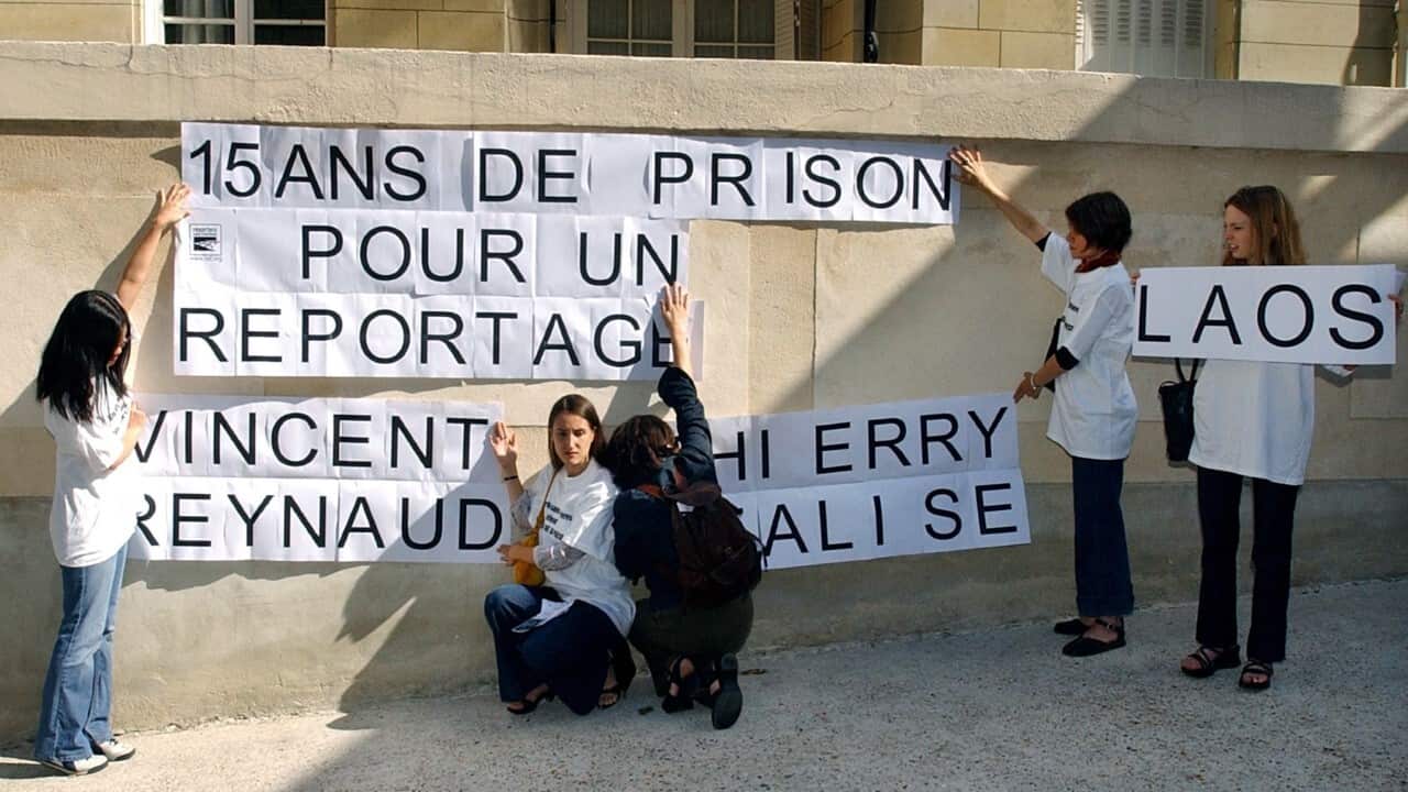 Without Borders posters on the wall of the Lao embassy in Paris after photojournalist Falise and cameraman Reynaud were 15-year jail by Laos