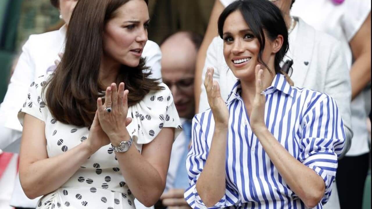 Kate and Meghan applauding the players after the match