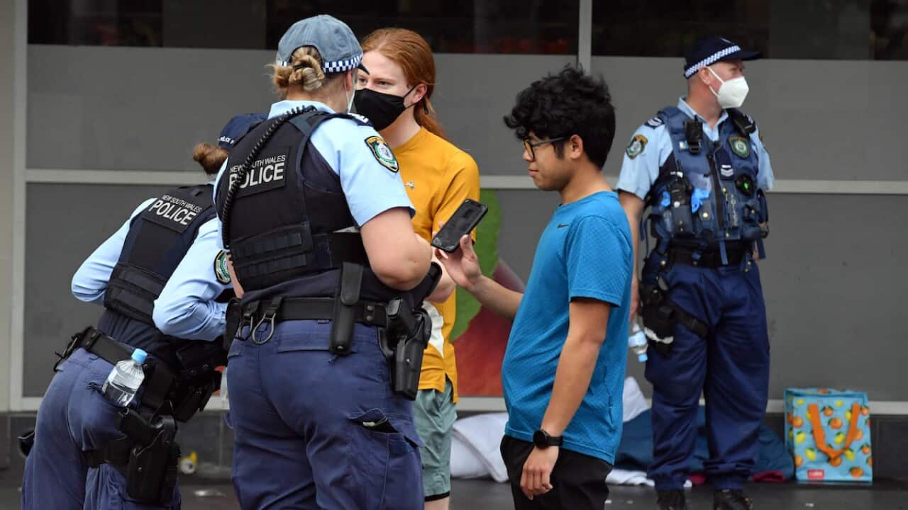 NSW police check identifications at George St in front of the Sydney Town Hall in anticipation of an anti-lockdown rally in Sydney Sydney, Saturday, July 31, 2021. (AAP Image/Mick Tsikas) NO ARCHIVING