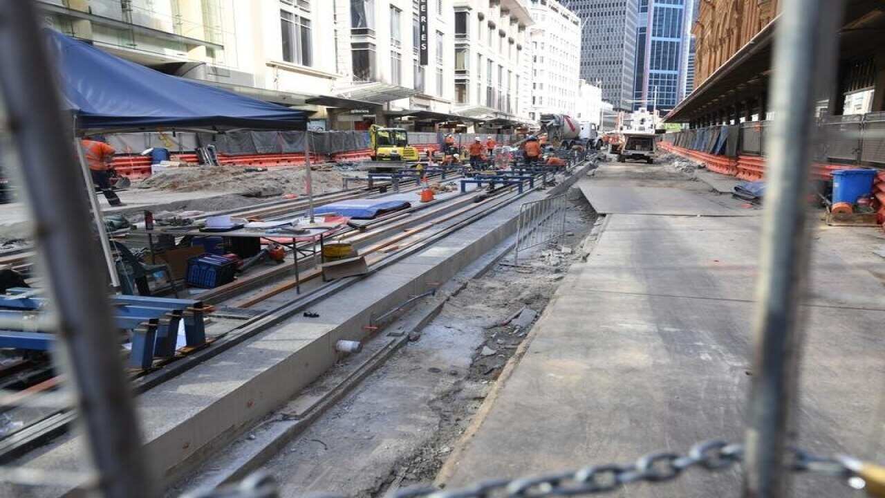Workers are seen on the George St, Sydney CBD Light Rail Project.