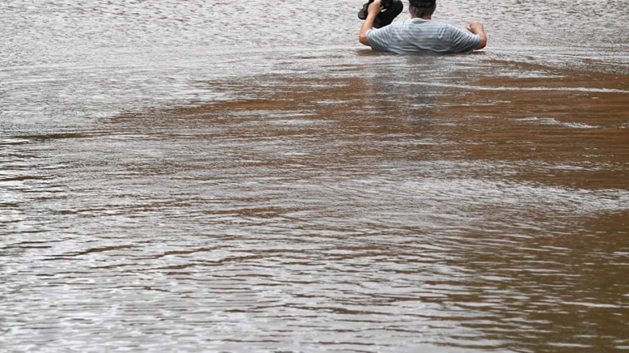 A man negotiates flood waters