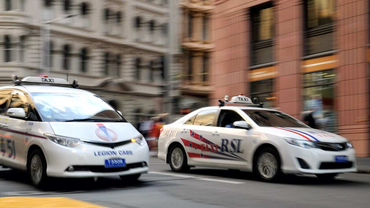 A taxi seen passing through the central business district in Sydney