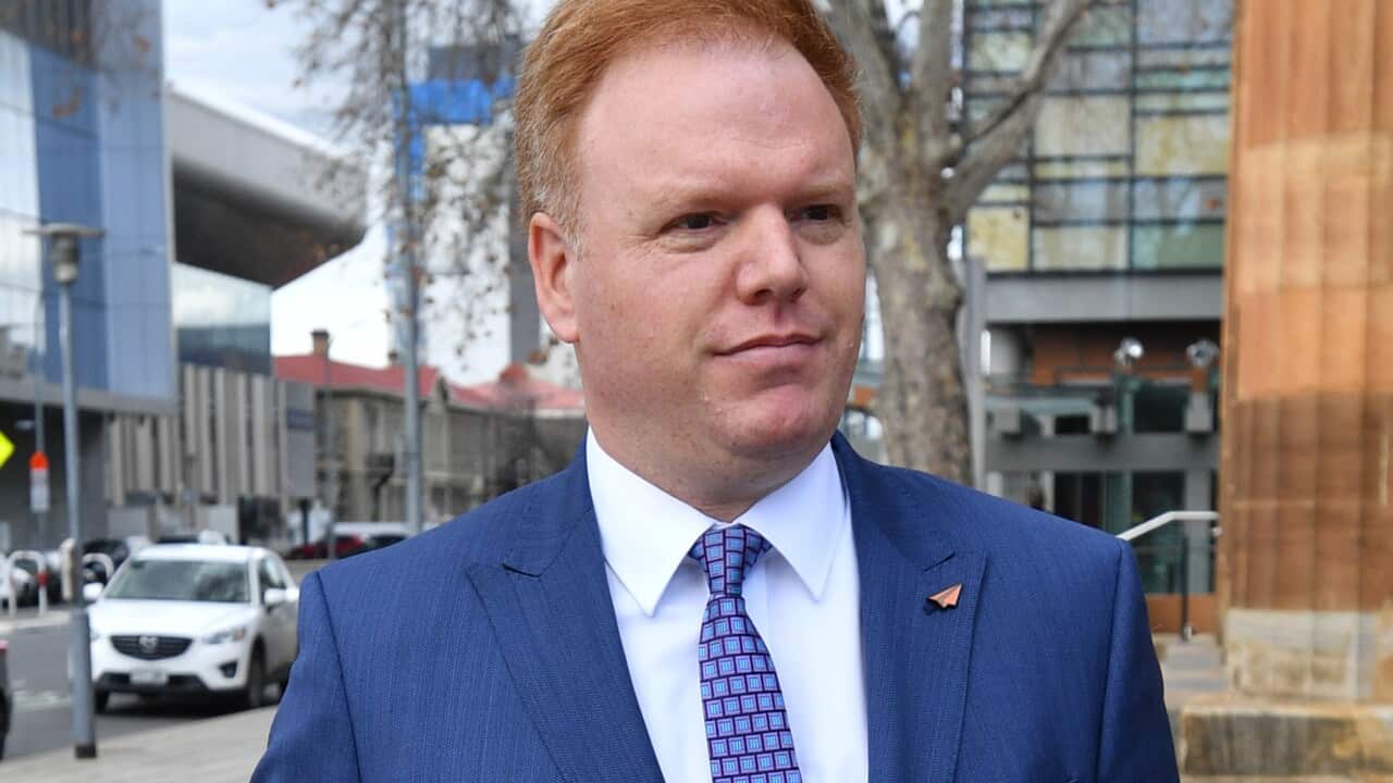 A man walking in a blue suit