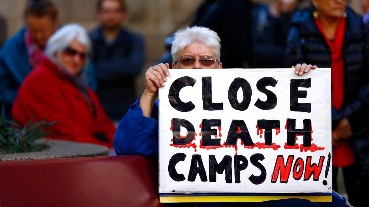 A protester holds a placard during the Evacuate Manus and Nauru Protest in Sydney last year