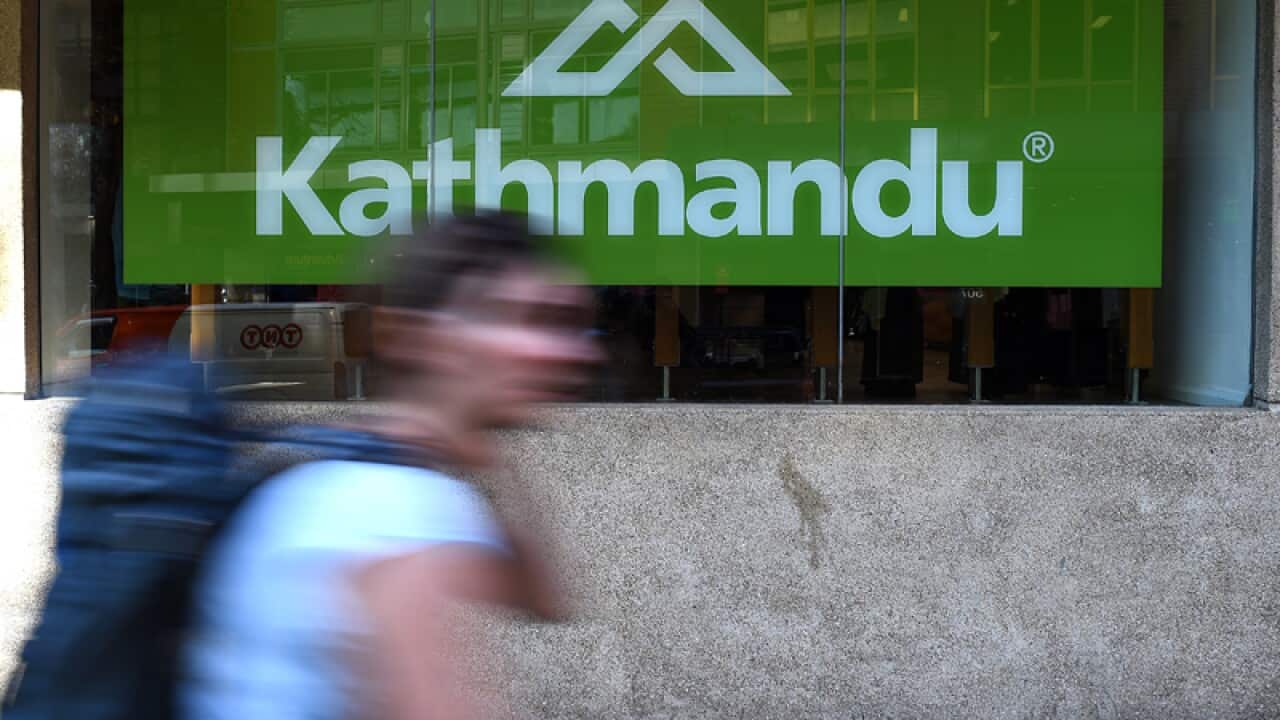 A pedestrian walks past a Kathmandu store