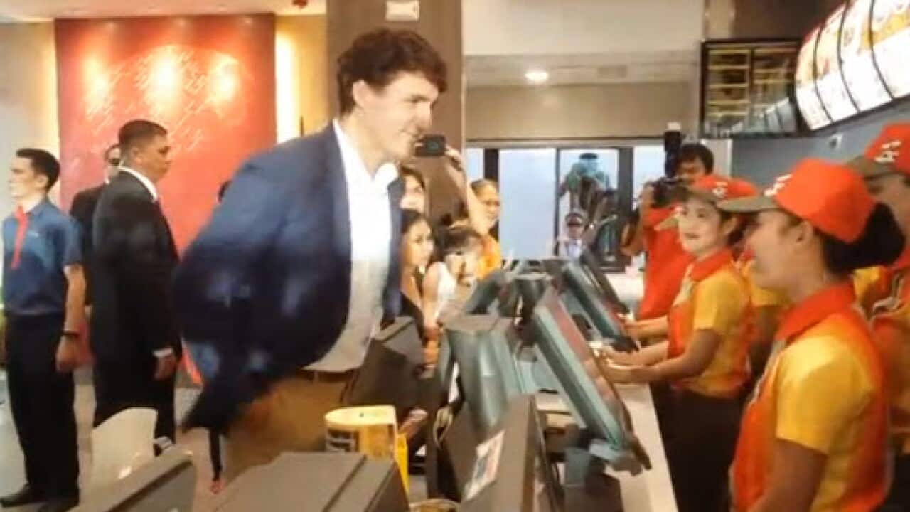 Canadian PM Justin Trudeau lines up to order fried chicken in Manila.