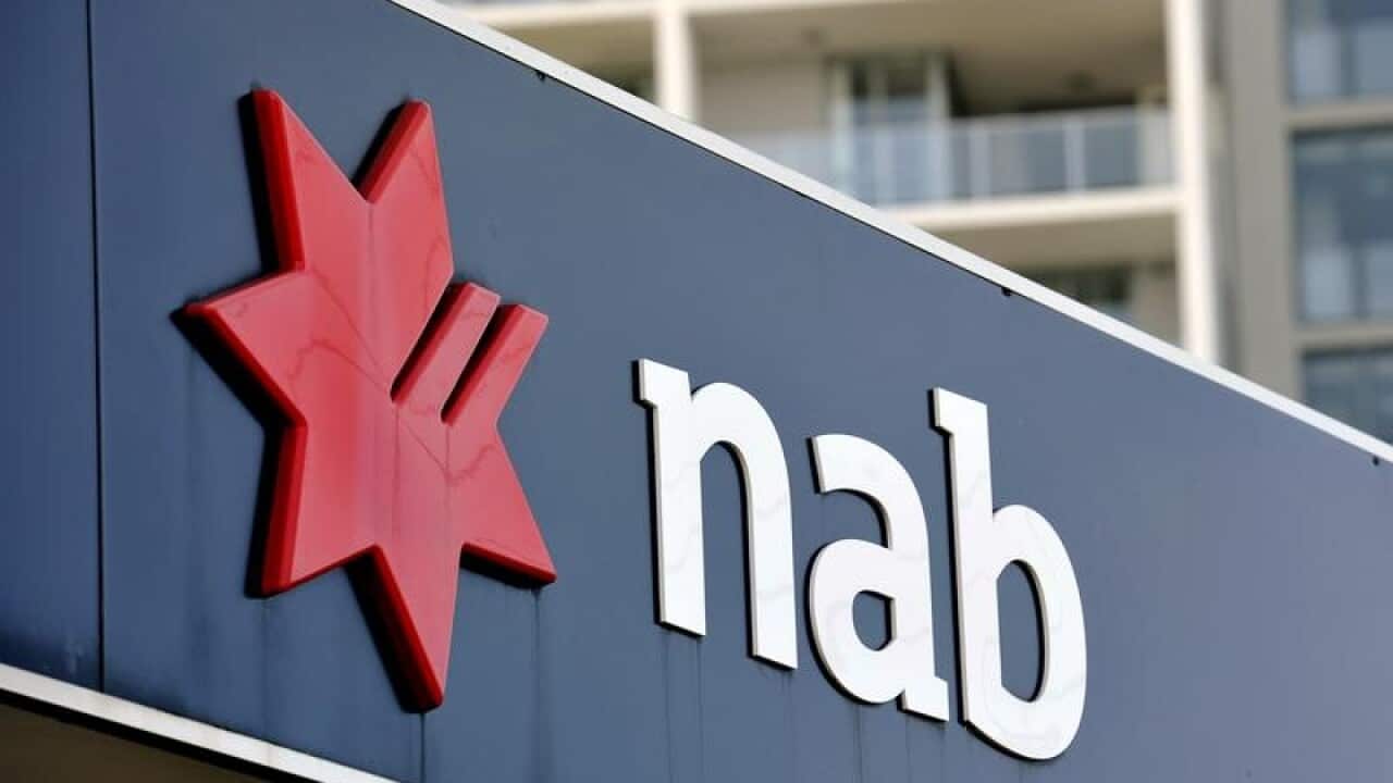Residential apartment housing seen behind NAB bank signage