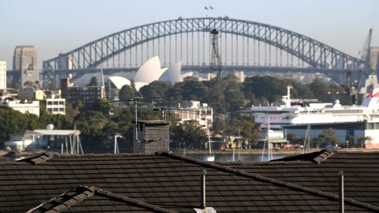 The Sydney Harbour Bridge is seen behindhousing in Sydney's east.