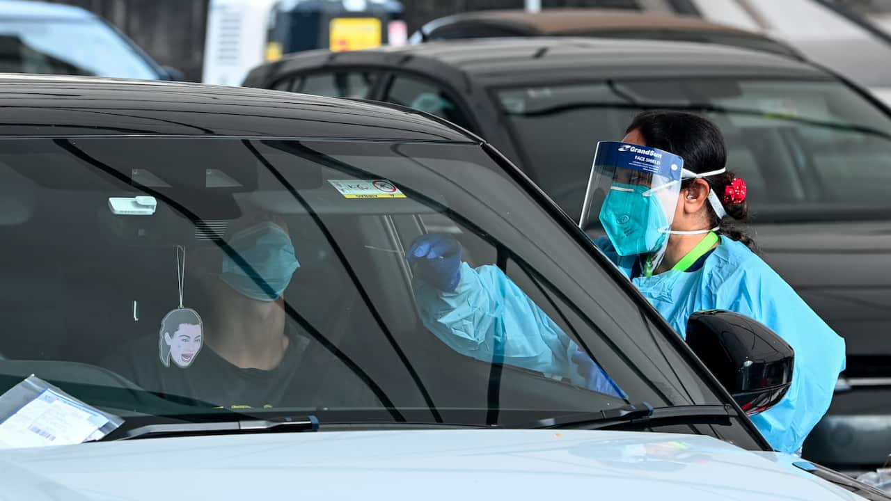 Health care workers administer COVID-19 PCR tests at the St Vincent’s Drive-through Clinic at Bondi Beach in Sydney earlier this year.