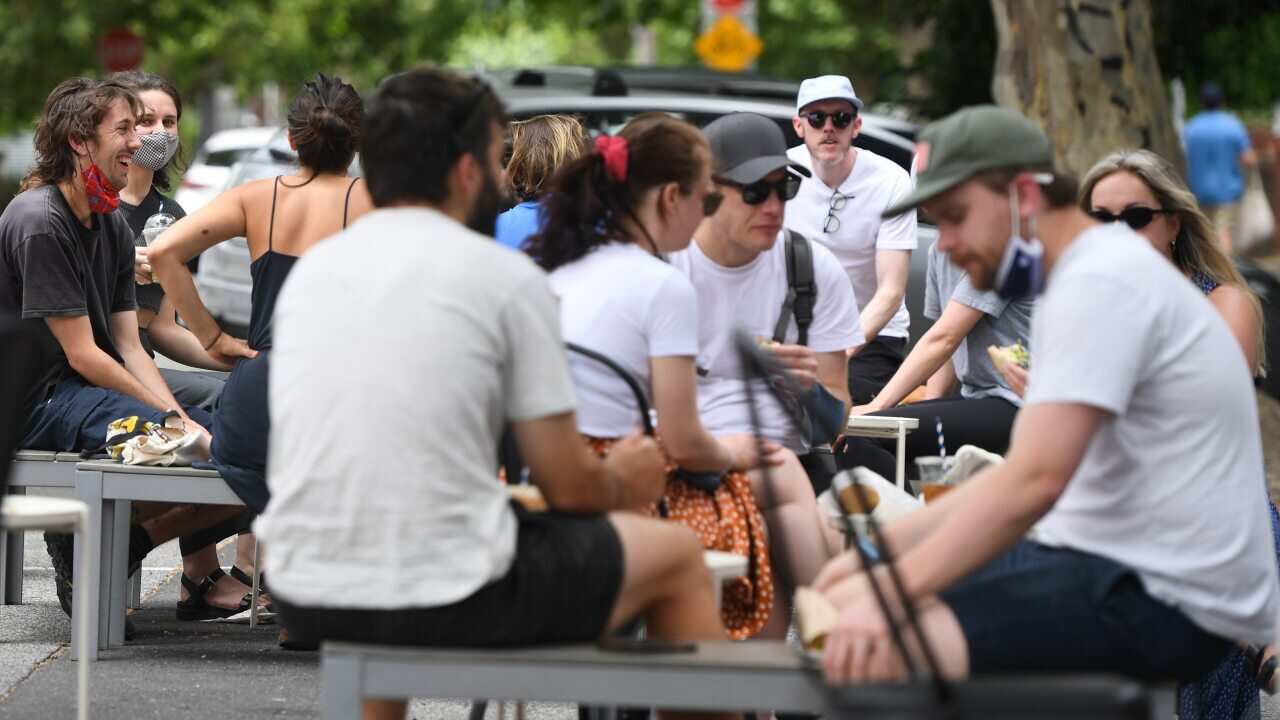 People are seen at a restaurant in Fitzroy, Melbourne, Sunday, 15 November, 2020.